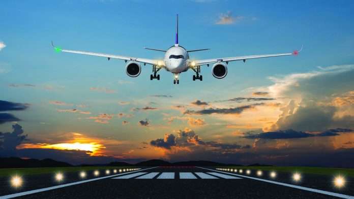 Airplane landing in the evening with beautiful sunset background